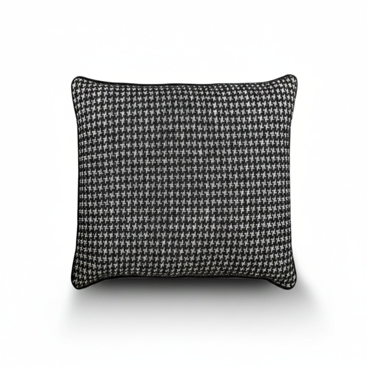 A square throw pillow featuring a classic black and white houndstooth pattern, finished with a solid black piped edge, shown against a plain white background with a soft drop shadow.
