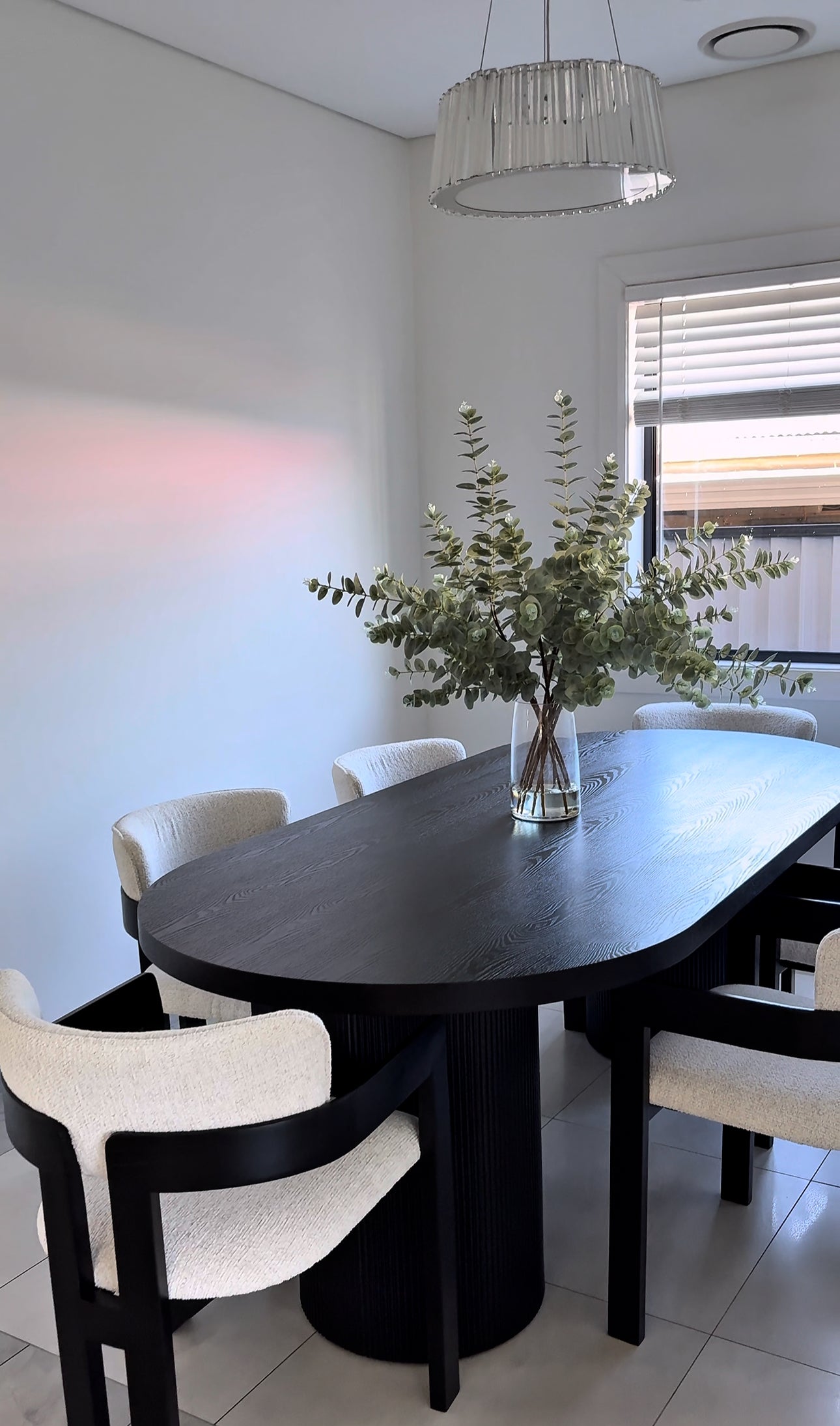Dining room with a vase of flowers.
