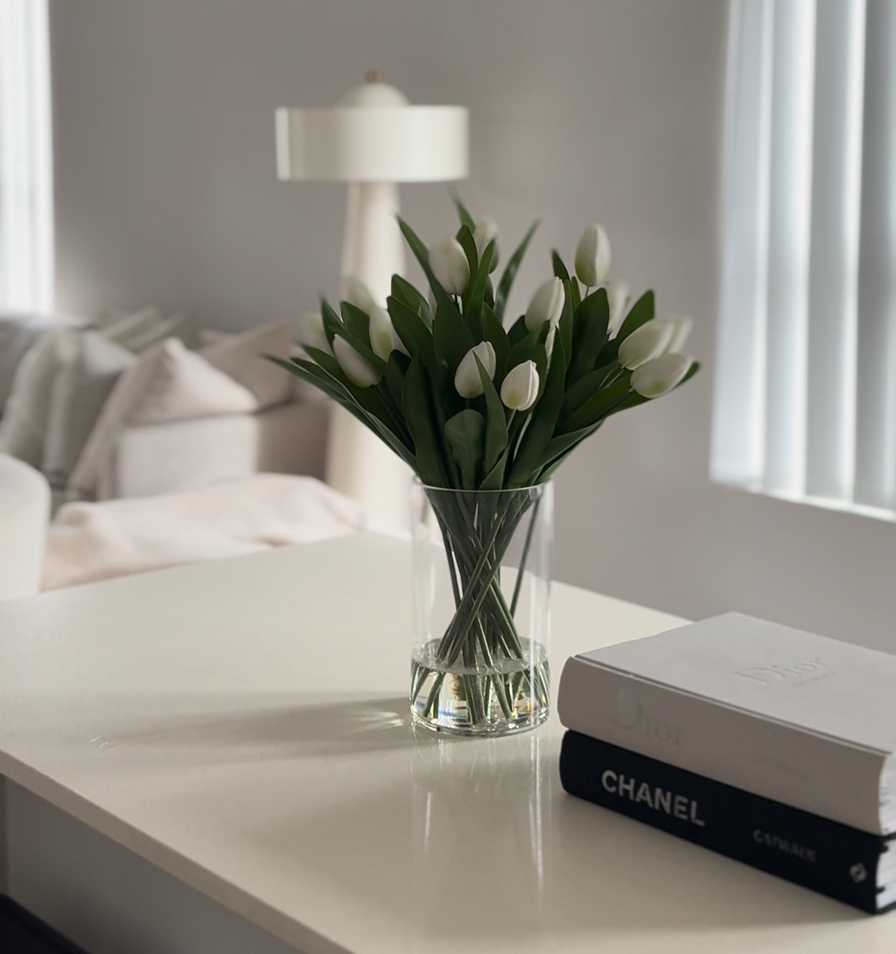 Artificial tulip arrangements and faux tulip stems styled in vase