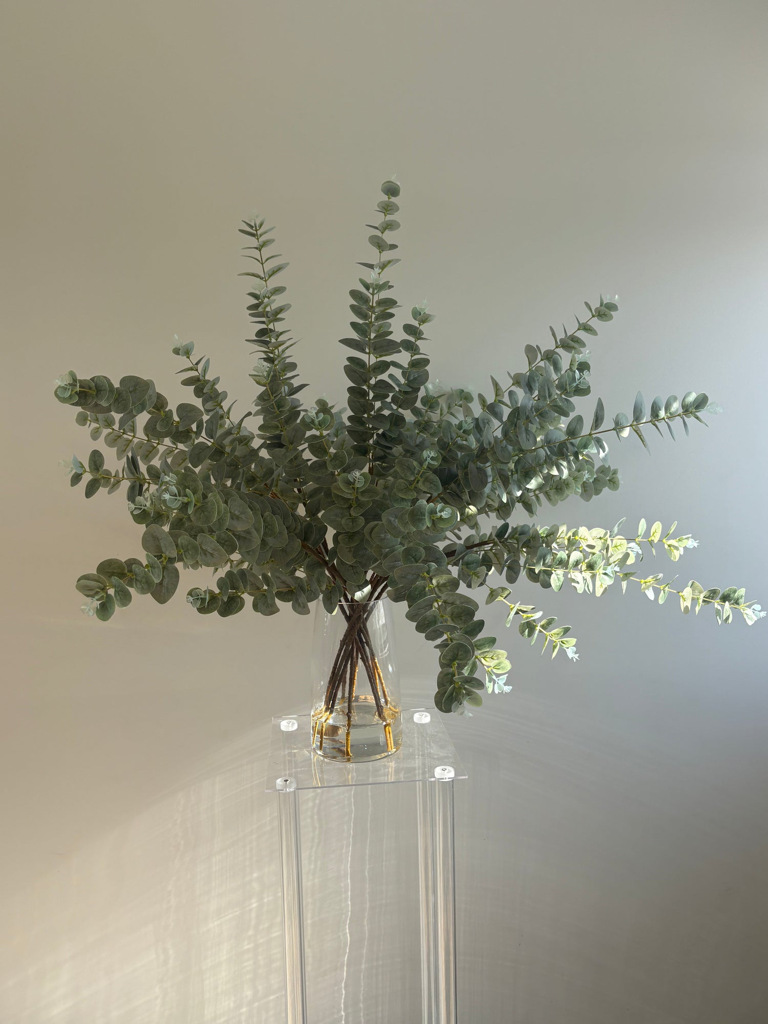 Artificial eucalyptus arrangements and faux eucalyptus stems styled in vase