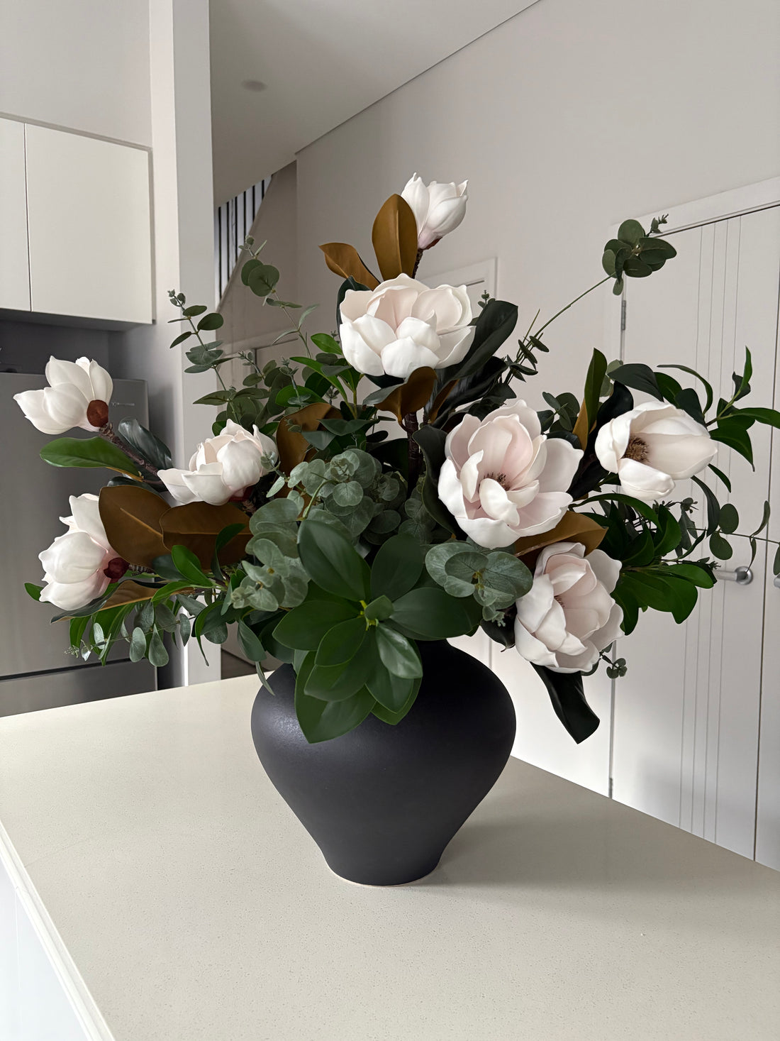 magnolia arrangement with black vase large