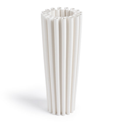 A modern cylindrical white ceramic vase with wave-like curves.