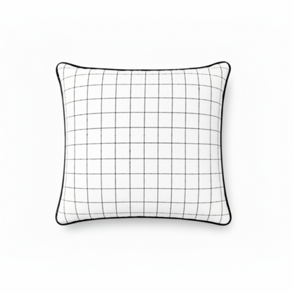 A square white throw pillow with a black grid pattern and a black piped edge, shown against a plain white background.