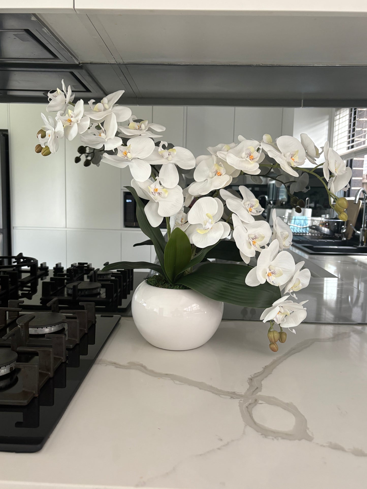 White orchid faux flowers styled in a premium vase for home décor
